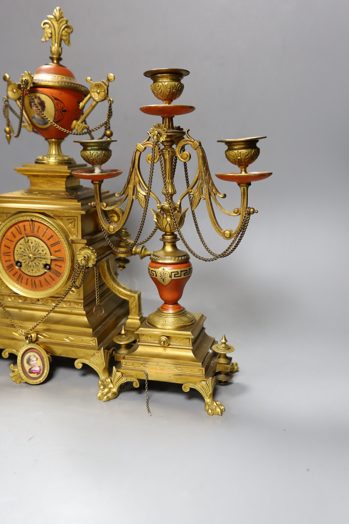 A late 19th century French Etruscan revival ormolu and porcelain mounted three piece clock garniture, 40cm